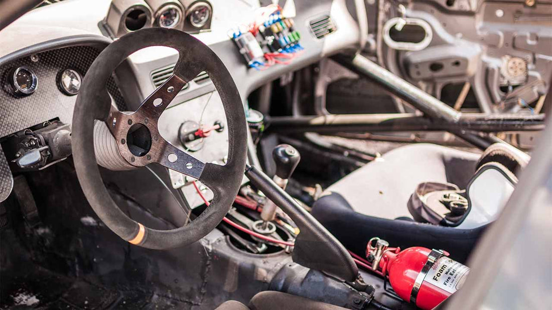 A collection of car parts and tools arranged on a dashboard, representing of the vehicle modifications.